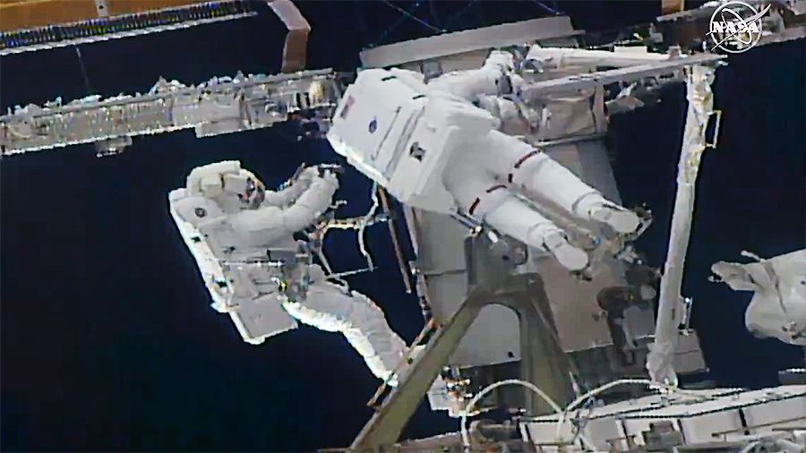 Spacewalking astronauts pack stubborn props to the first space station for new sunrises