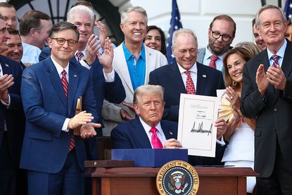 President Donald Trump, joined by Republican lawmakers, signs the One, Big Beautiful Bill Act into law during an Independence Day military family picnic on the South Lawn of the White House on July 04, 2025