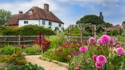 Exterior of white clapboard Grade II listed farmhouse in Sussex