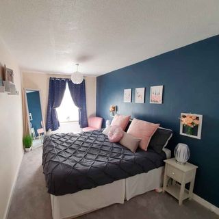 bedroom with photoframe on blue wall