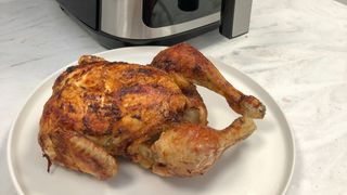 A whole chicken cooked in the Paris Rhône Air Fryer