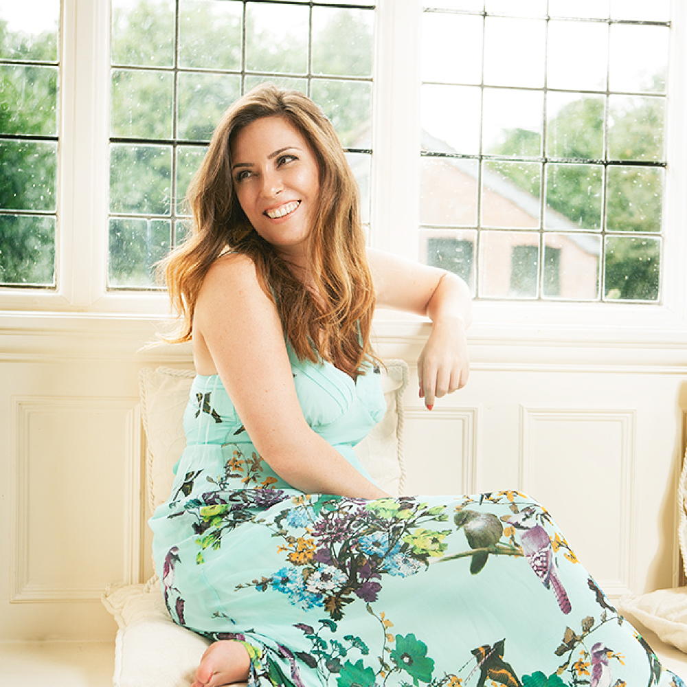 home with glass windows and smiling lady