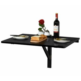 A wall-mounted black dining room table with a meal on it