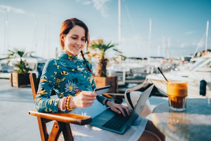 Woman at summer vacation shopping online