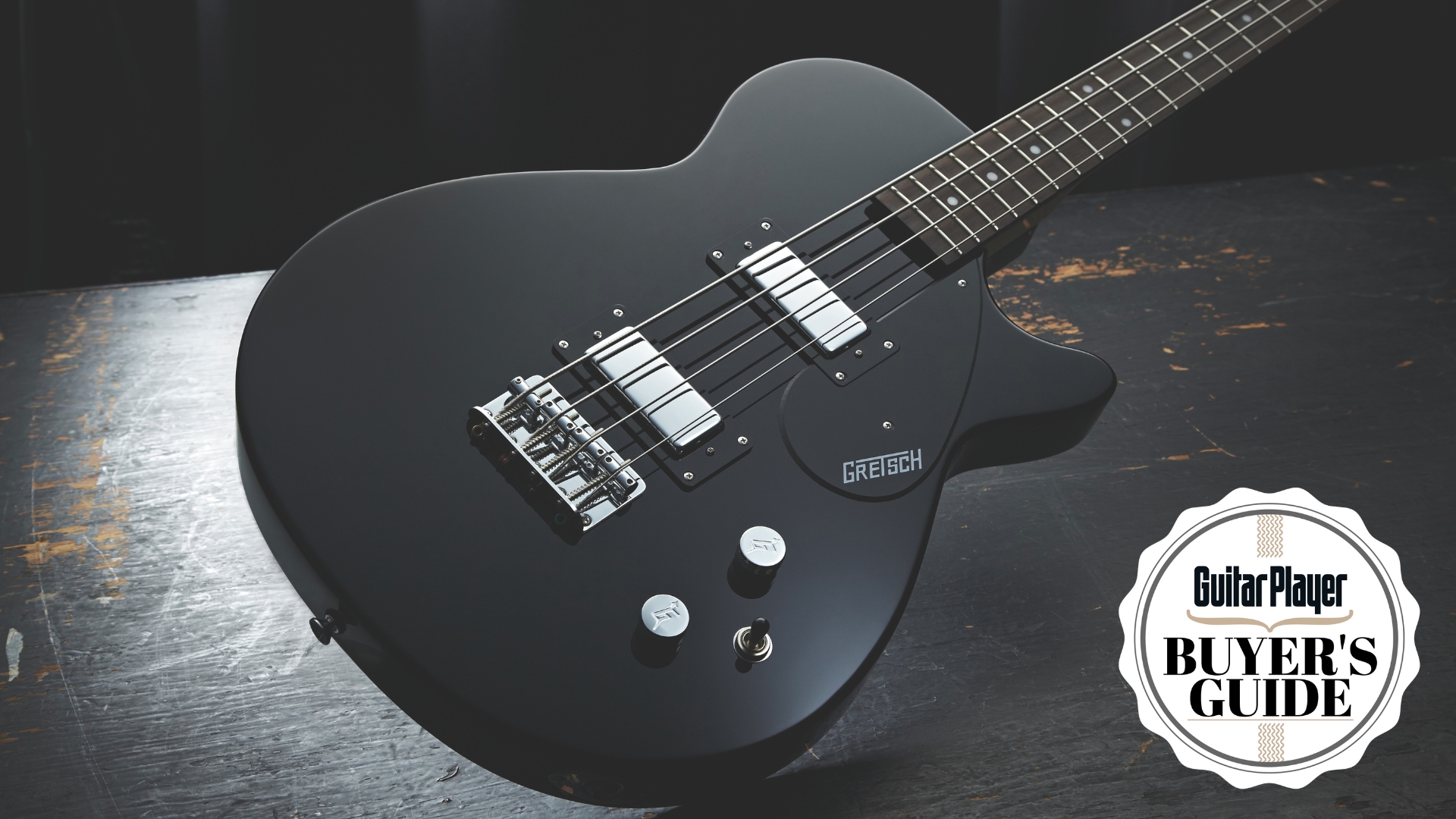 A Gretsch G2220 bass guitar on a wooden table