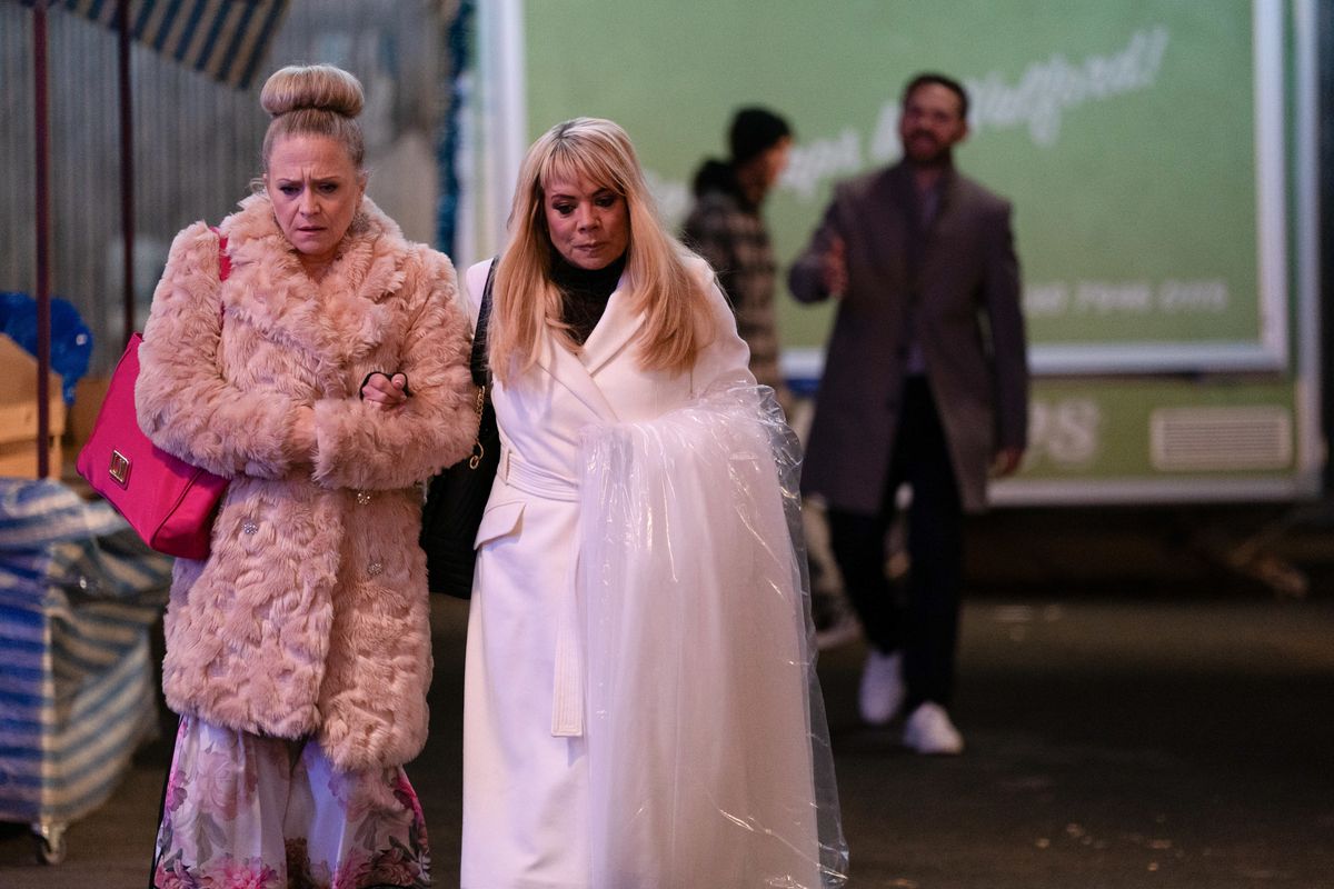 Sharon Watts and Linda Carter collect her wedding dress