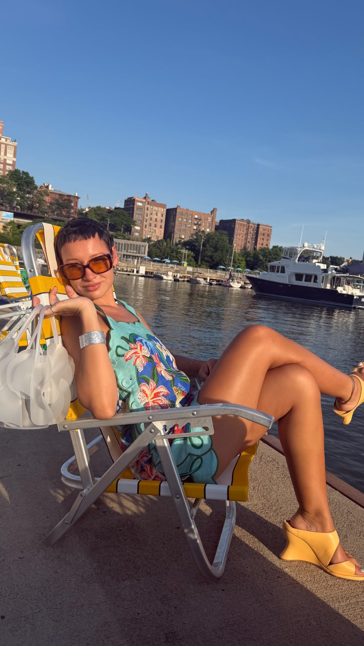 Influencer @aishafarida wears sculputral wedges with a teal minidress.