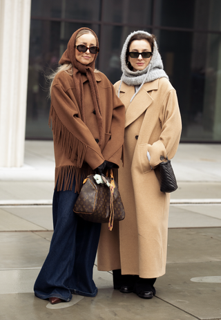 fashion show guests wear knit babushka bonnets at Copenhagen Fashion Week Autumn/Winter 2025 on January 29, 2025