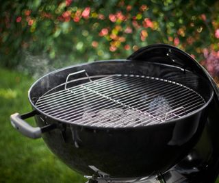 lit charcoal grill with lid off