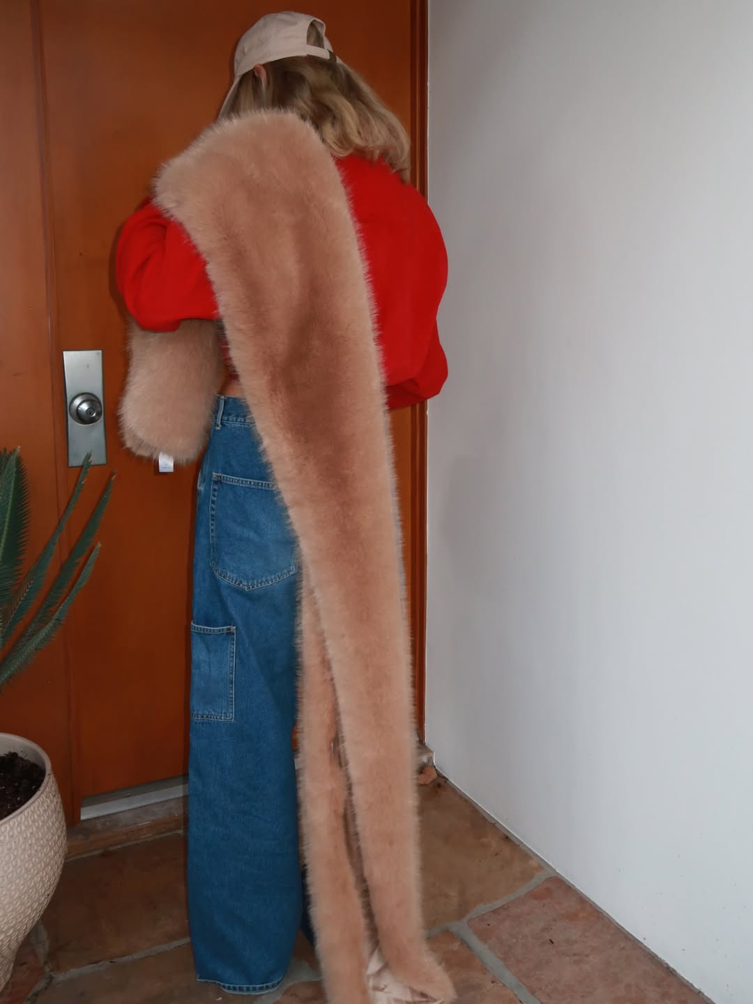 Elsa Hosk wearing the faux-fur scarf trend.