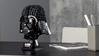 Lego Darth Vader's Helmet on a table against a gray background