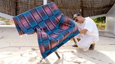 colourful woven mats folded over bamboo chairs