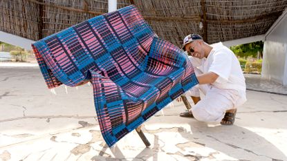colourful woven mats folded over bamboo chairs