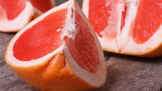 A close-up of grapefruit wedges on a countertop