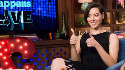 Aubrey PLaza giving a double thumbs up on a TV show.