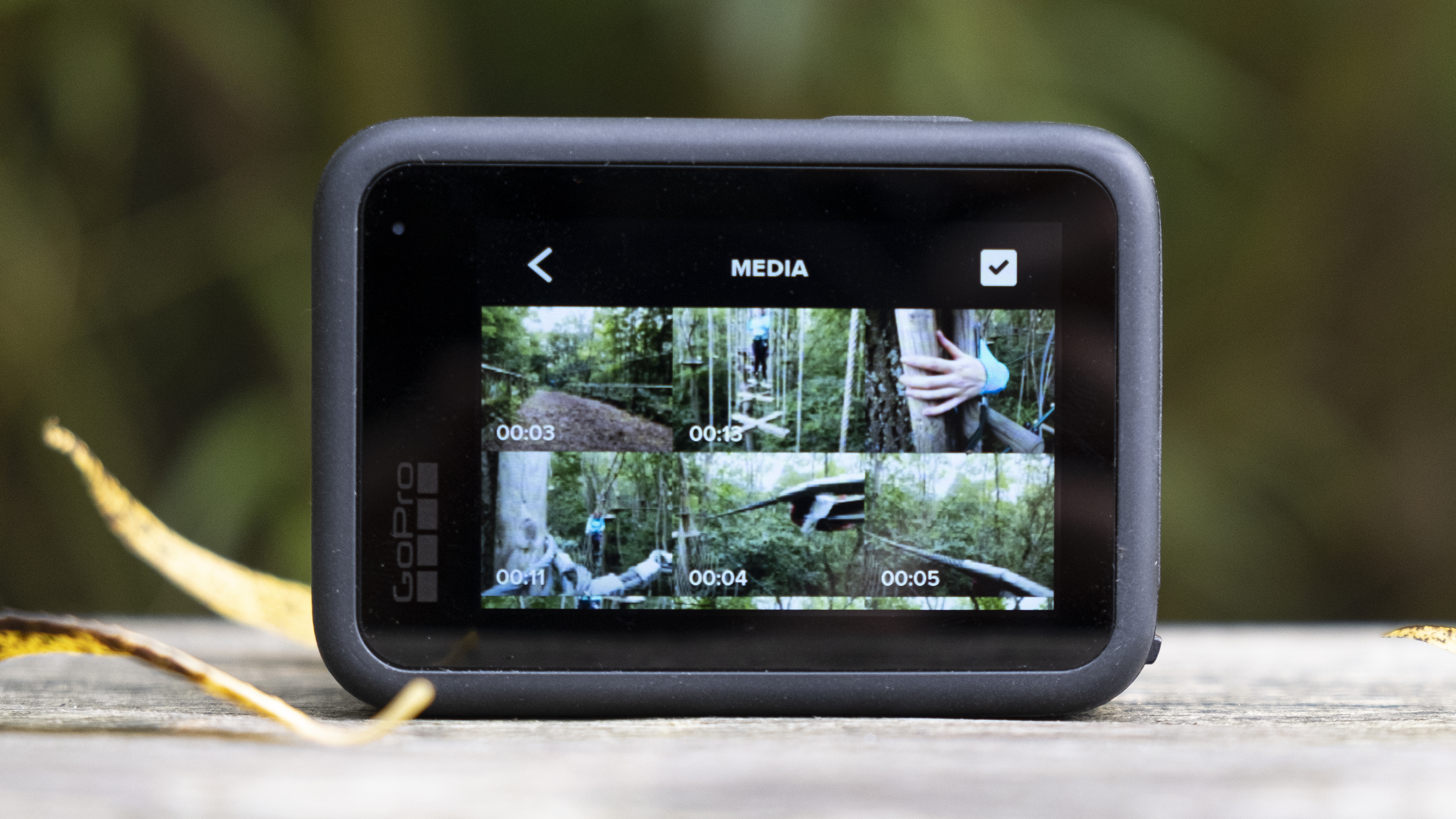 The GoPro Hero 10 Black action camera sitting on a wooden bench