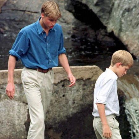 Prince William and Prince Harry walking on rocks at Balmoral