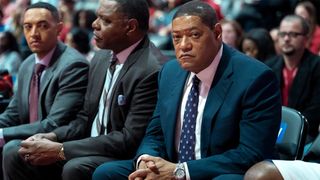 Laurence Fishburne as Doc Rivers sitting alongside the basketball court in Clipped