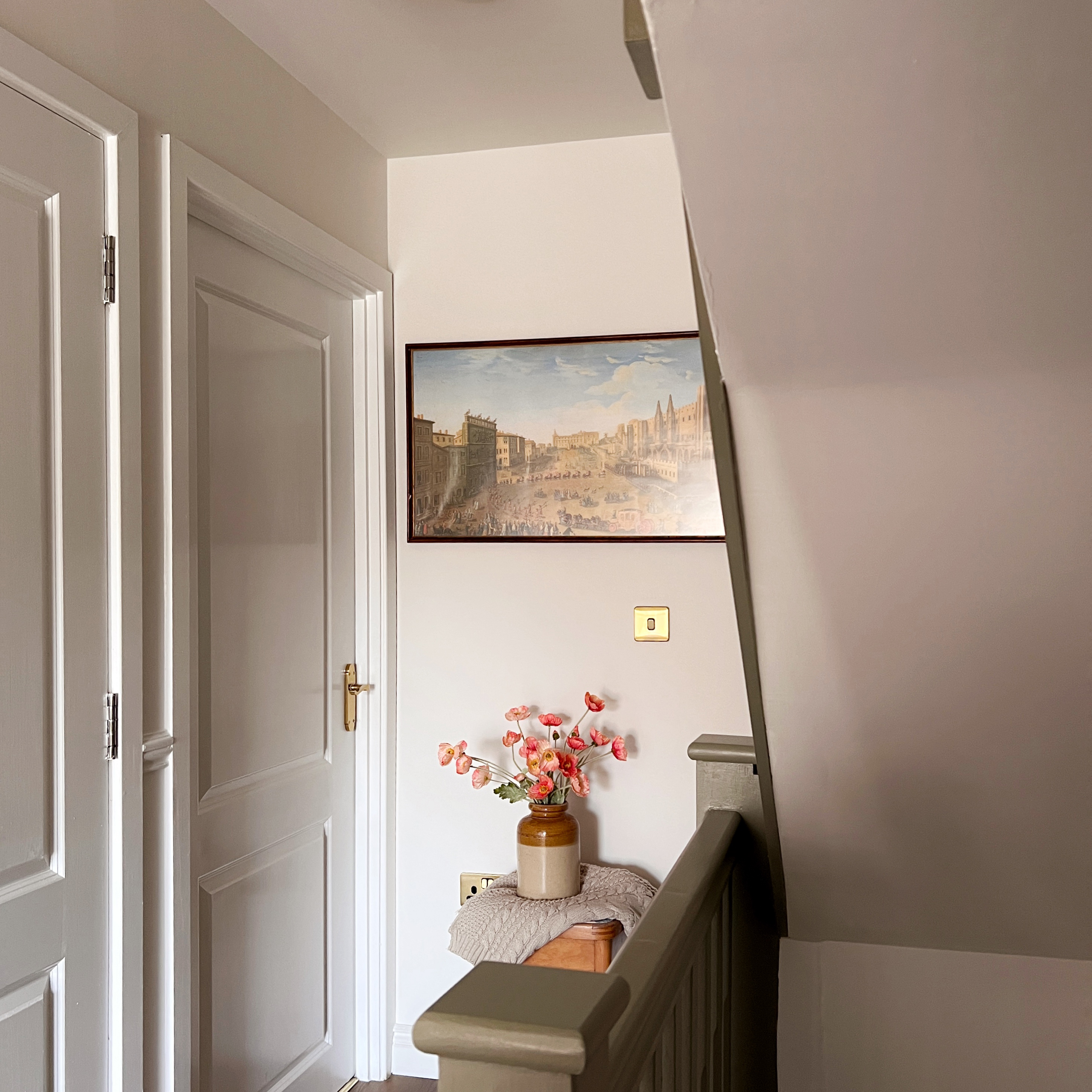 white landing with art on the walls