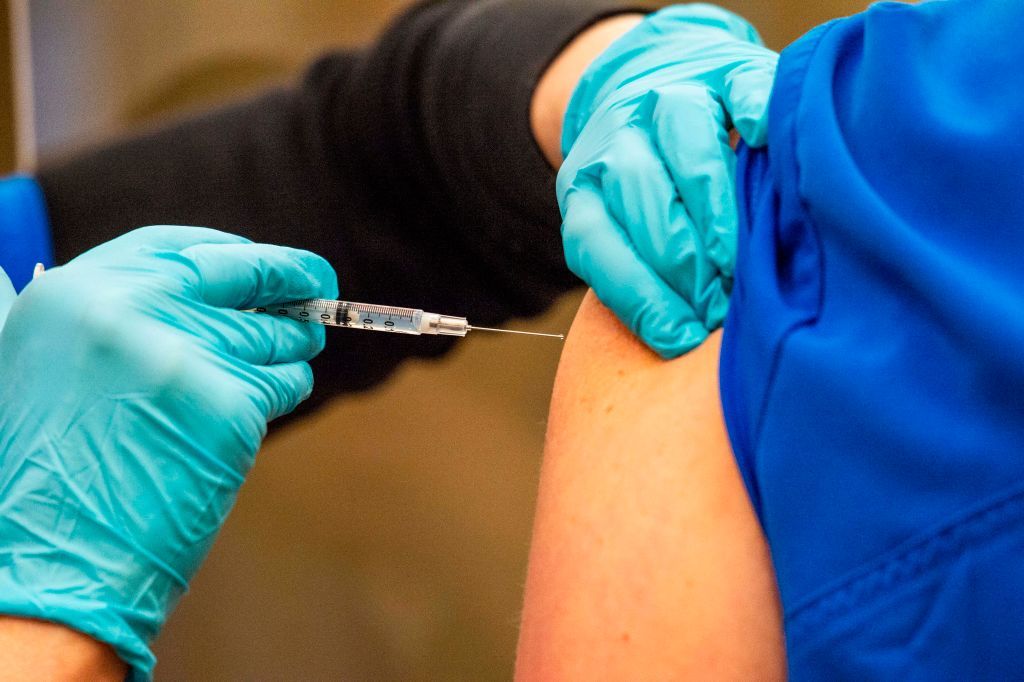 Front line workers receive a dose of the Pfizer and BioNTech COVID-19 vaccine