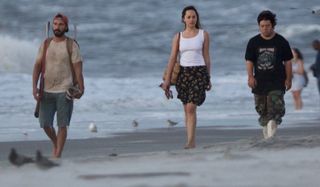 The Peanut Butter Falcon Shia LaBeouf Dakota Johnson and Zack Gottsagen walking on the beach