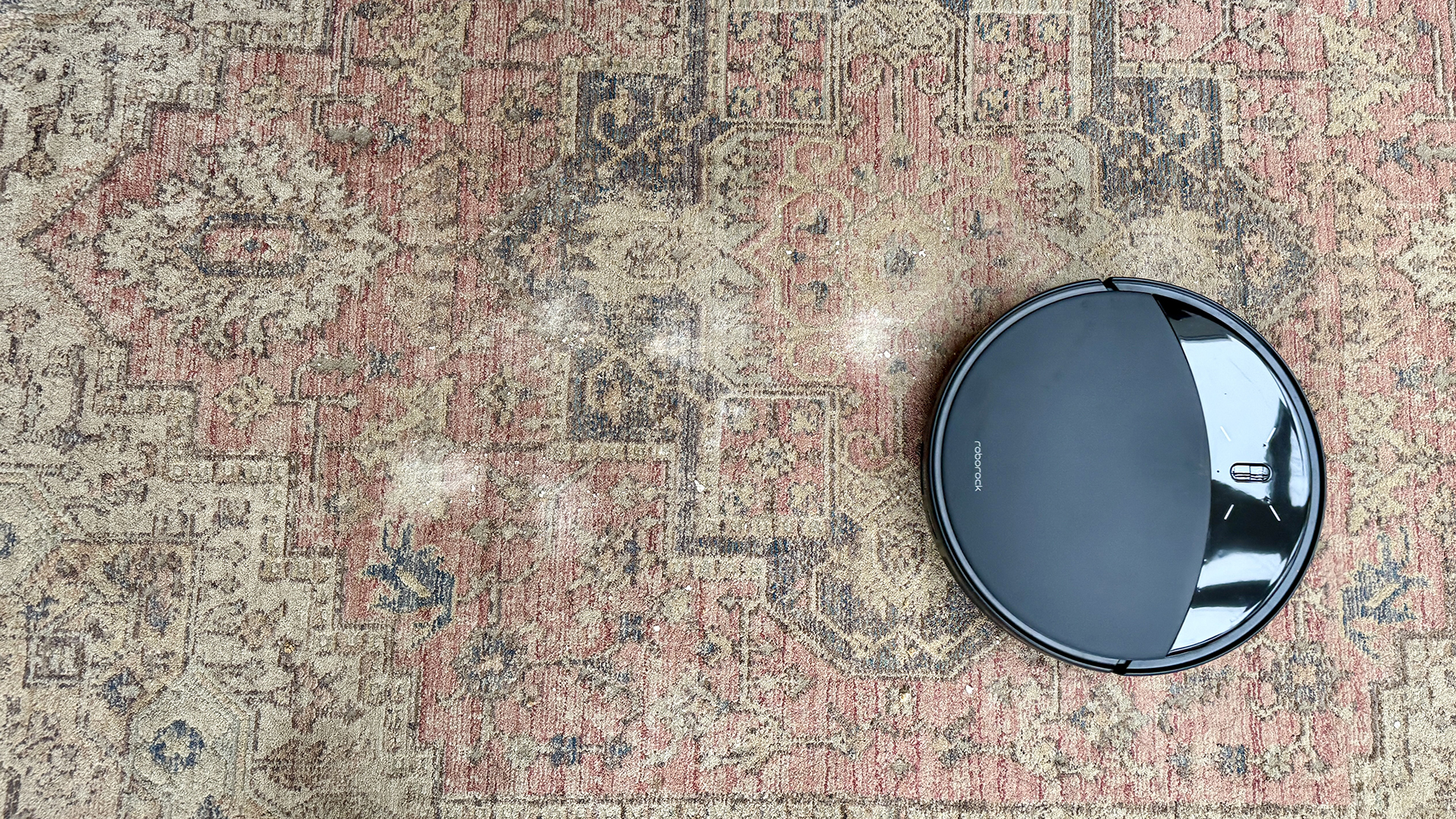 Roborock Saros 10R robot vacuum and mop after completing vacuuming test on carpet