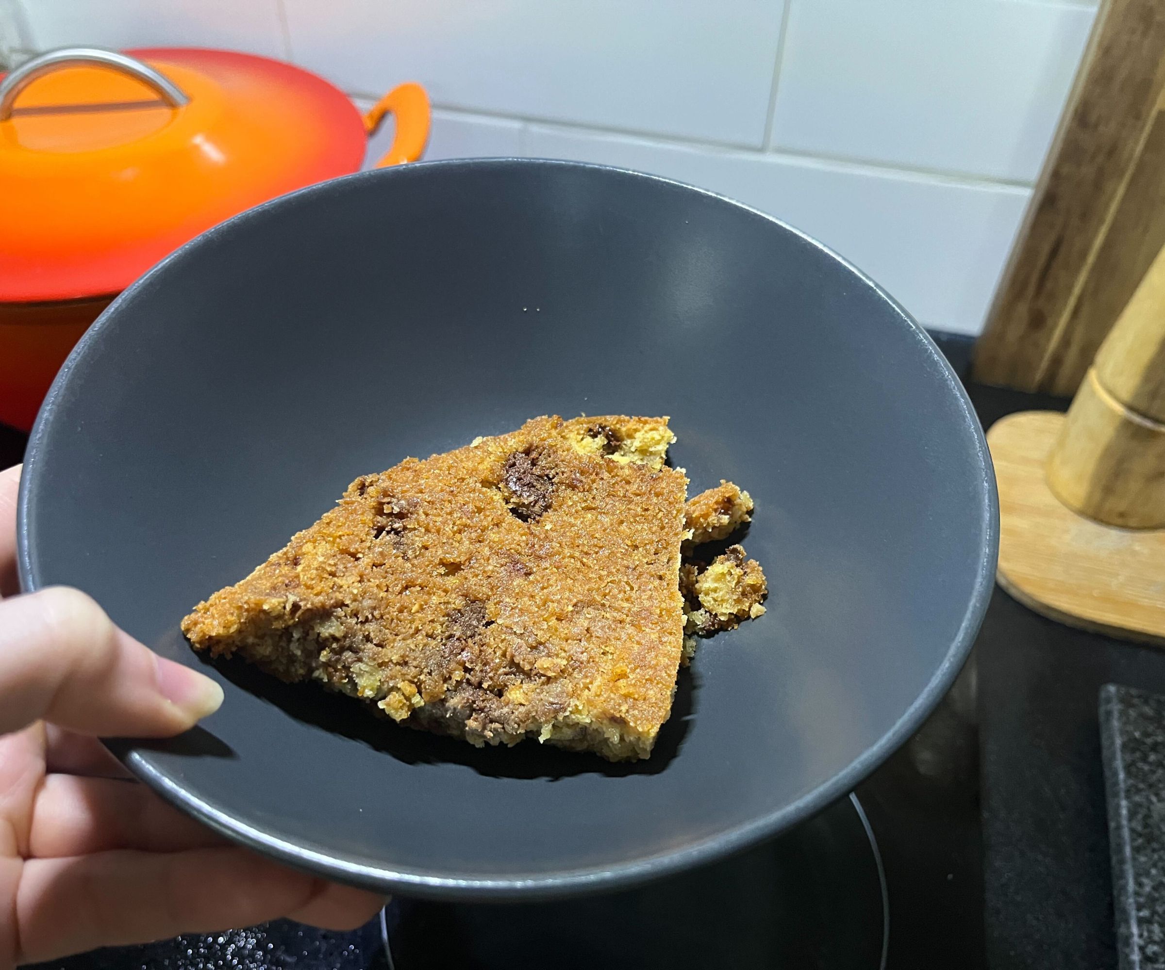 The crisp base of a skillet cookie in a grey bowl