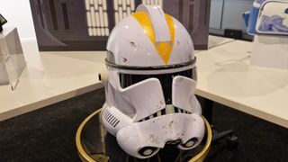 212th Clone Trooper Helmet on a table, with Star Wars decorations in the background