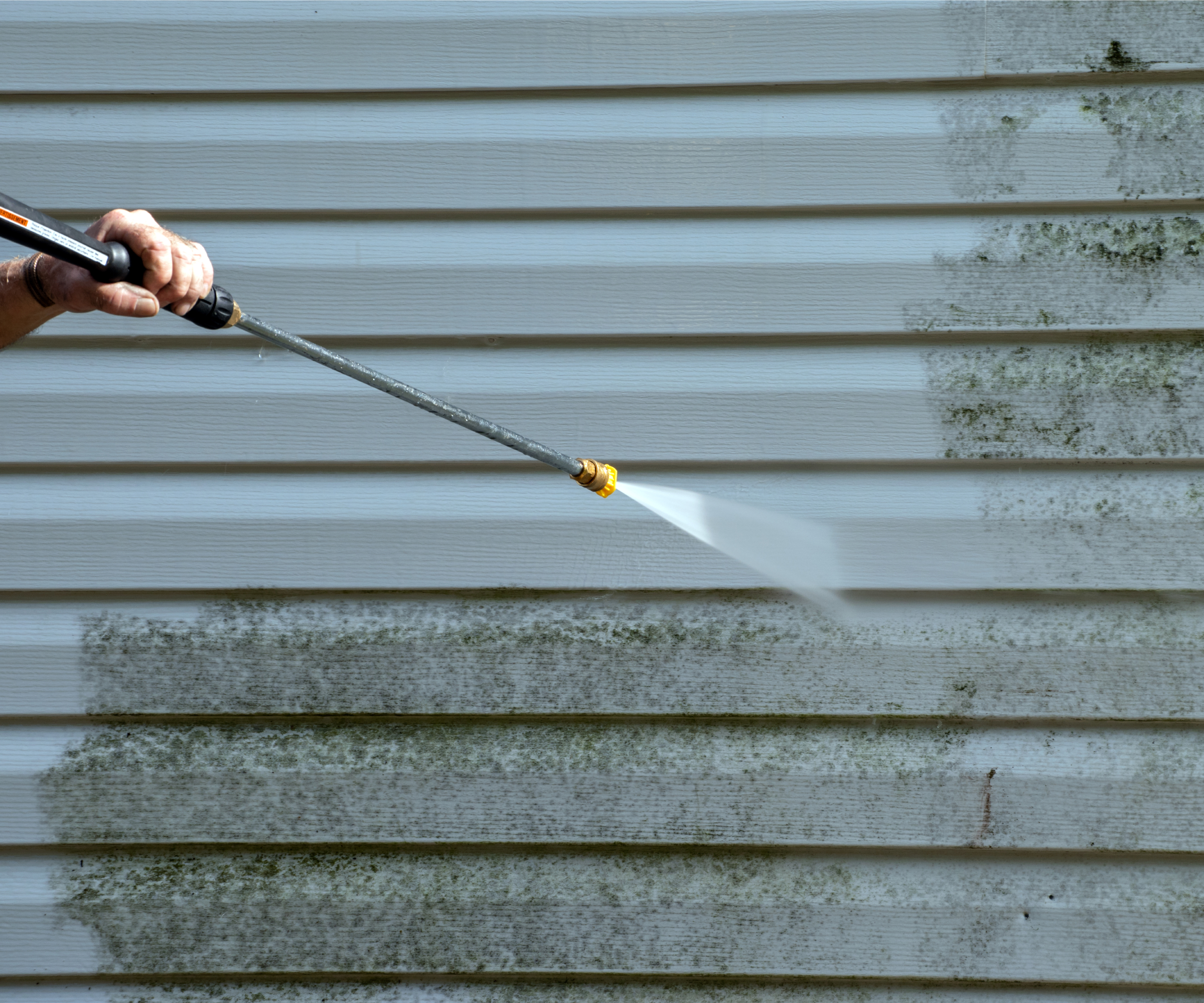 jet washing weatherboard cladded wall