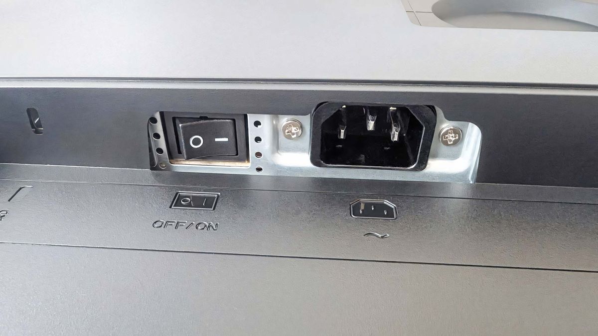 A close-up of the ASUS ProArt PA27JCV's power switch and power port.