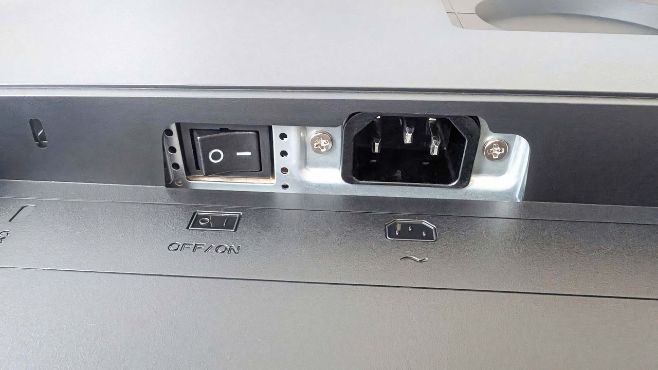 A close-up of the ASUS ProArt PA27JCV's power switch and power port.