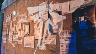 A shot of various posters and promotional material for the Last of Us show on a ruined wall