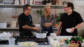 Three people (a chef, Gwyneth Paltrow, and Jon Favreau) stand in a commercial kitchen, in 'The Chef Show.'