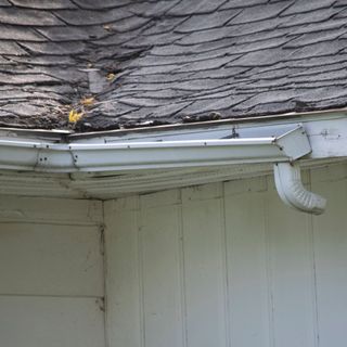 White gutter sagging on a white cladded building