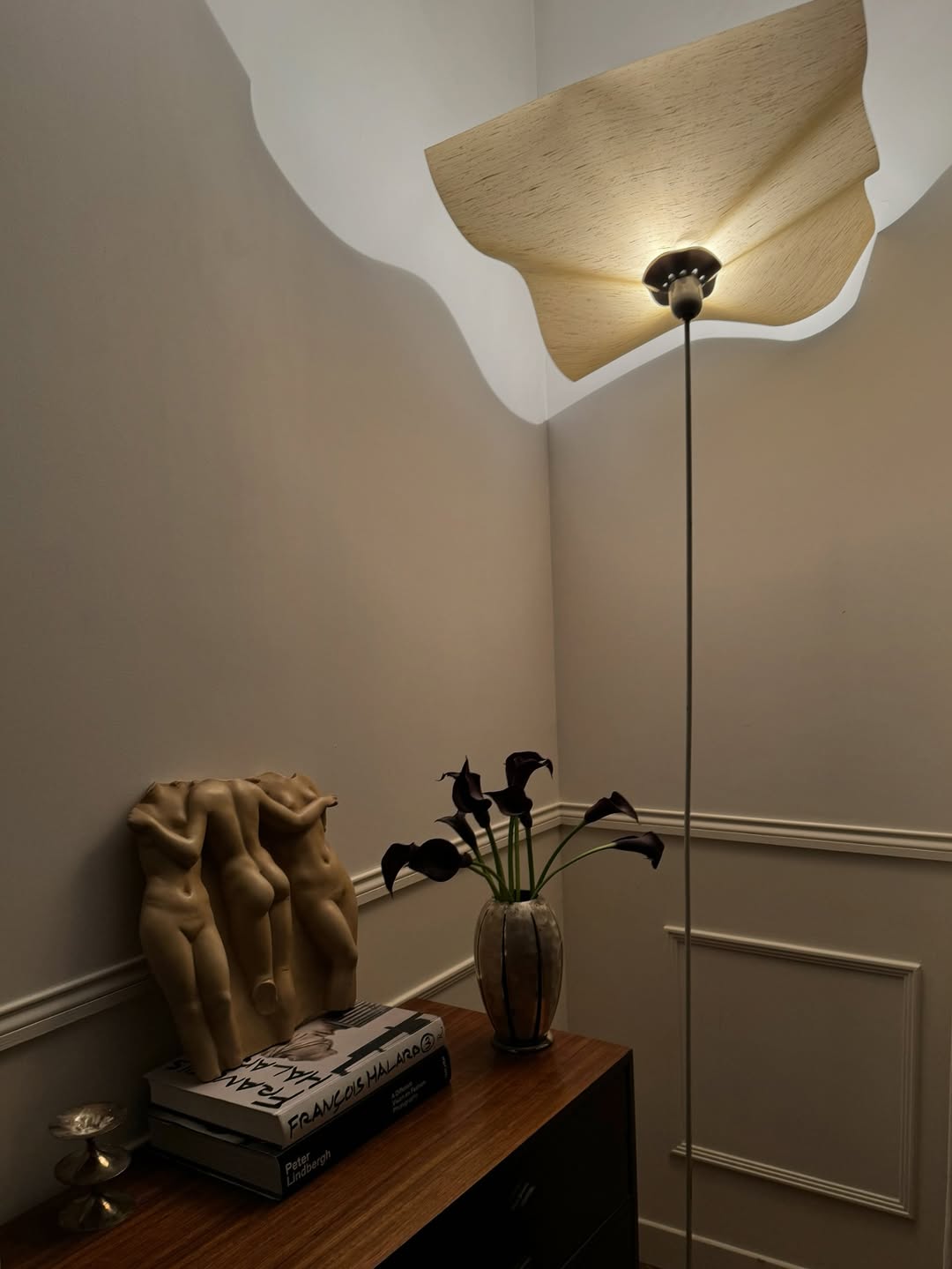 Lamp next to sculpture of women