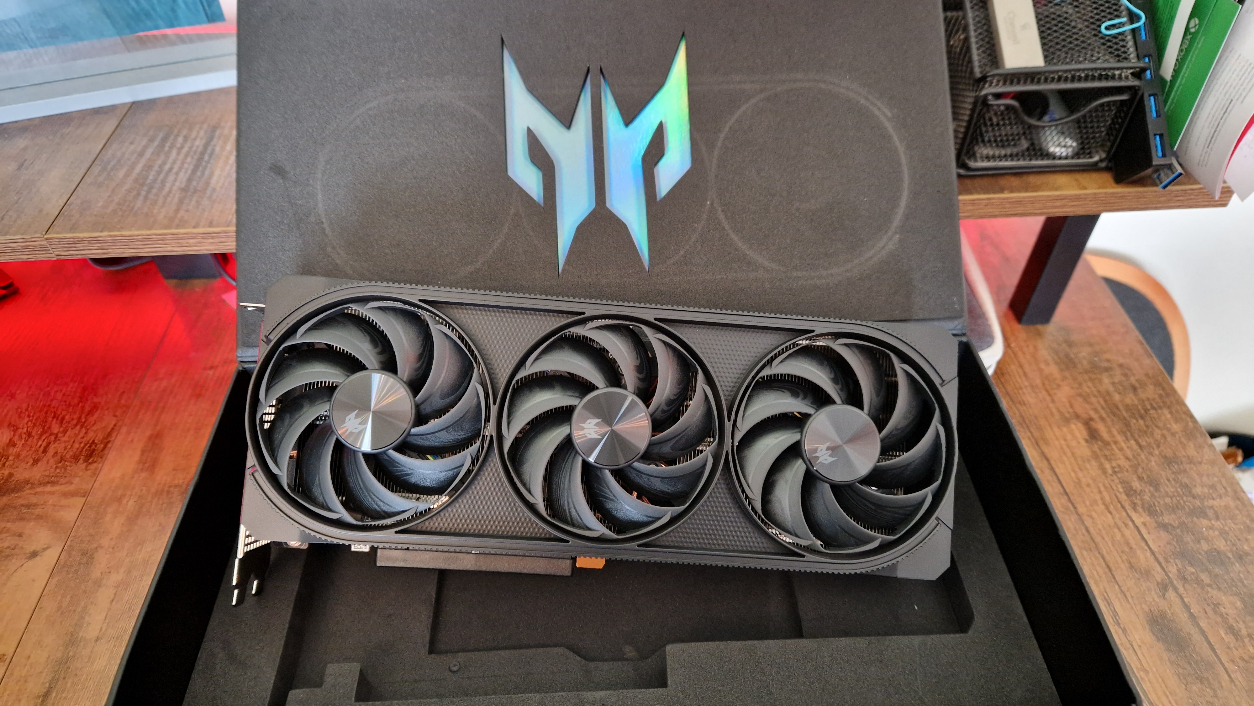 AMD Radeon RX 7800 XT elevated in its box, in front of an Acer predator logo