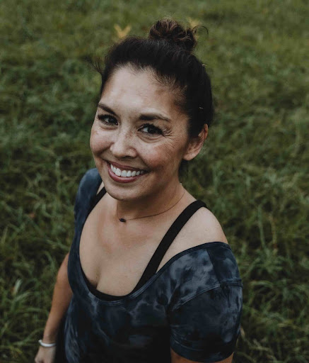 a head and shoulders shot of a female yoga instructor