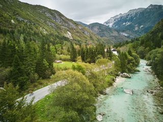 A cyclist riding next to a Slovenian river