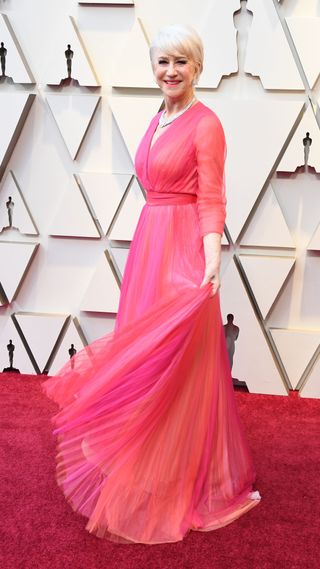 Helen Mirren wearing a pink dress on the red carpet