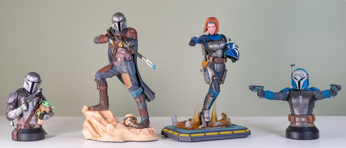 The Mandalorian and Bo-Katan Kryze Mini Busts and statues from Gentle Giant, lined up against a green background