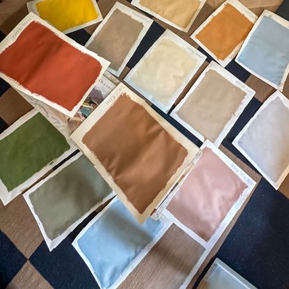 red, green, blue and brown paint swatches laid out on a table