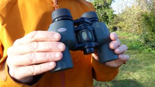 Man holding Kowa YF 8x30 binoculars