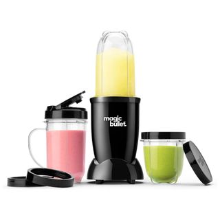 A Magic Bullet blender and the various pitchers, each filled with (left to right) a berry, orange, and green smoothie
