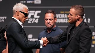 Charles Oliveira and Justin Gaethje shaking hands at a press conference for UFC 274
