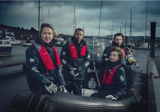 The cast of crime drama Annika on a boat under cloudy skies