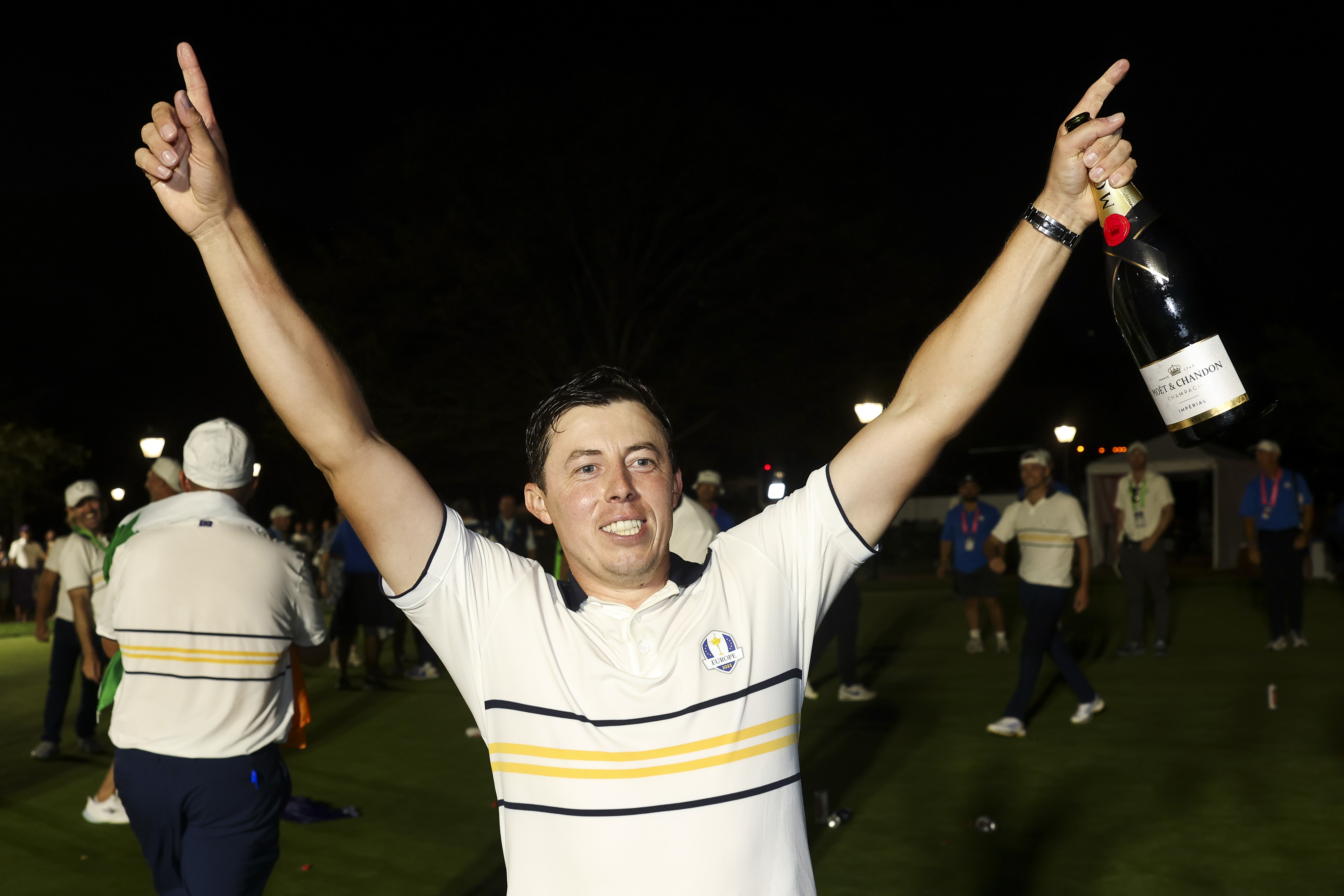 Matt Fitzpatrick with his hands in the air and a bottle of champagne celebrating Europe&#039;s 2025 Ryder Cup victory