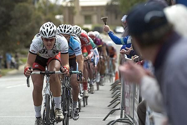 Miles Watson (Titans-Race) drives the peloton towards Dennis at the bell-lap.