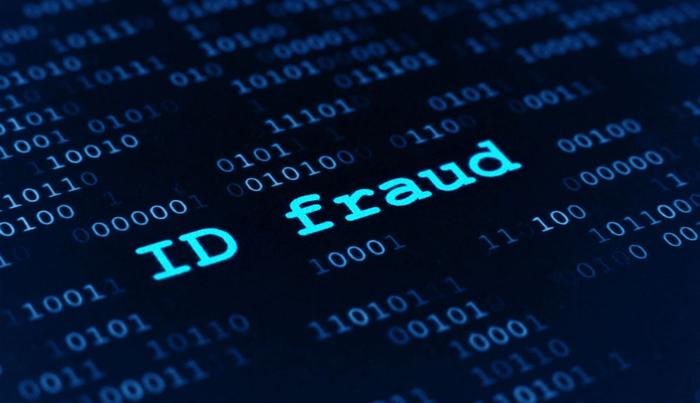 Words 'ID Fraud&amp;quot; highlighted on dark field of ones and zeros.