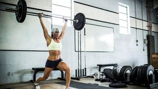 Woman lifting weights over head