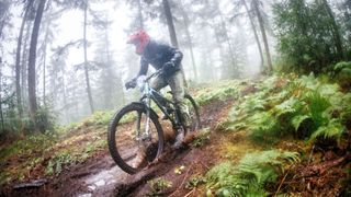 A MTB rider in deep mud